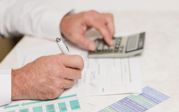Hombre realizando cuentas con una calculadora